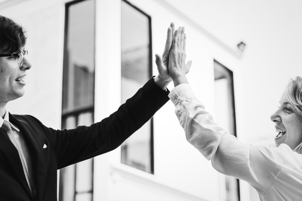 Businesspeople giving a high five together