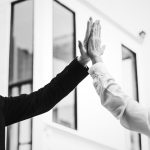 Businesspeople giving a high five together